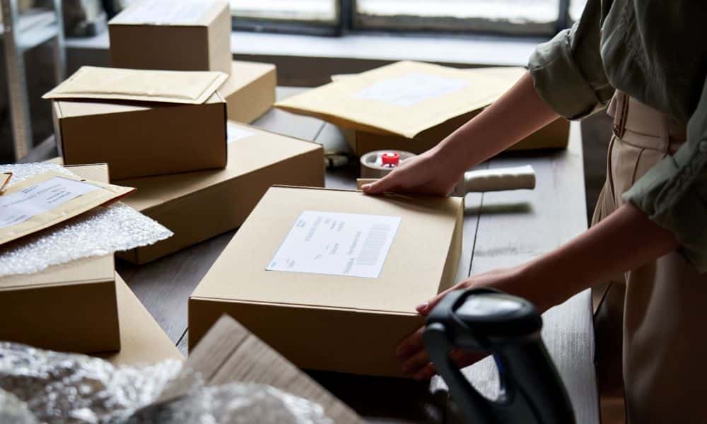 A cropped photo of a person preparing packages