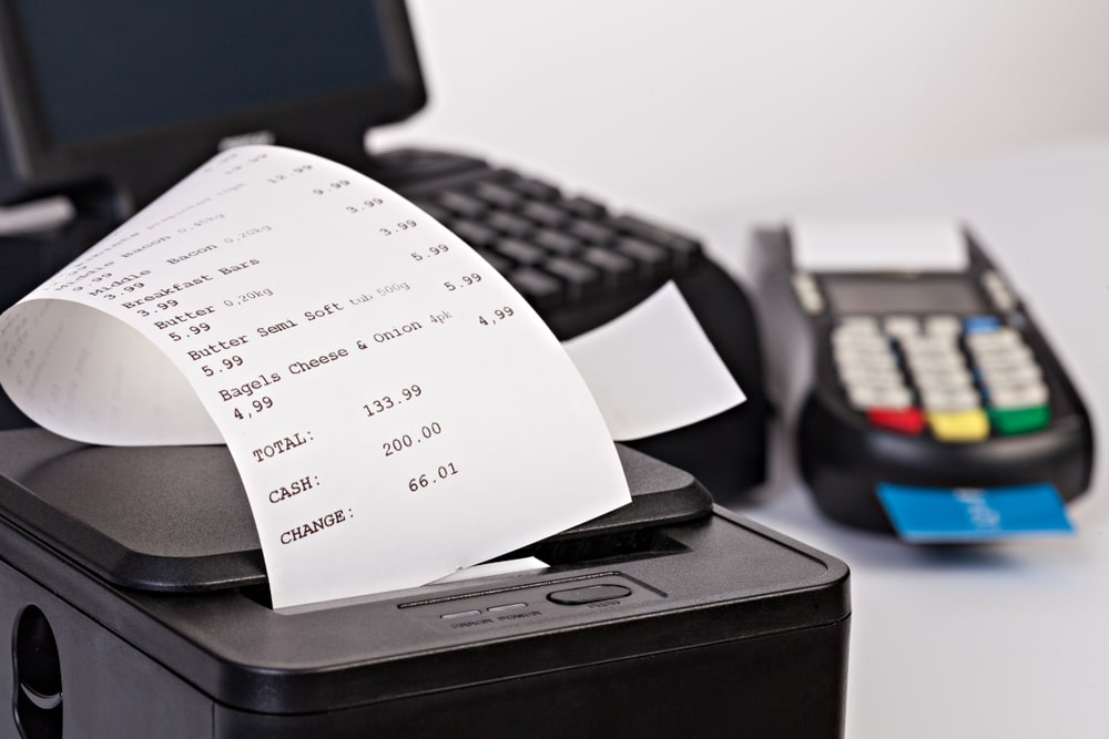 Cash register printing receipt.