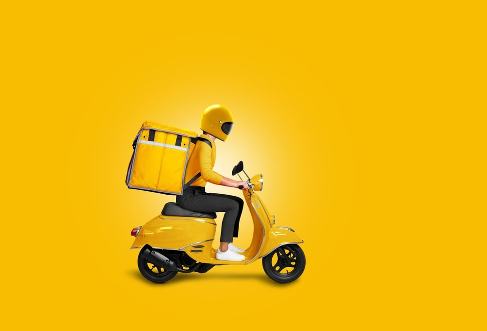delivery rider on a yellow scooter