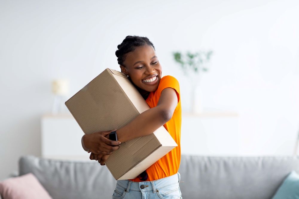 Smiling woman hugging a package