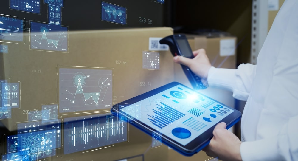 A person holding a tablet with graphs and a scanning tool