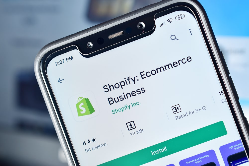 A phone reflecting the Shopify mobile app