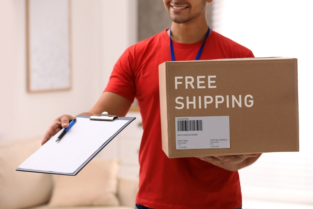 delivery man holding a free shipping box