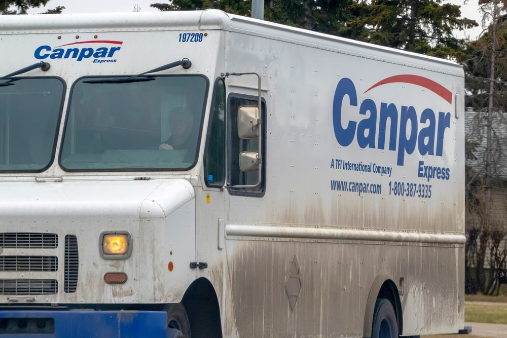 a white Canpar Express truck with blue text and a blue and white logo