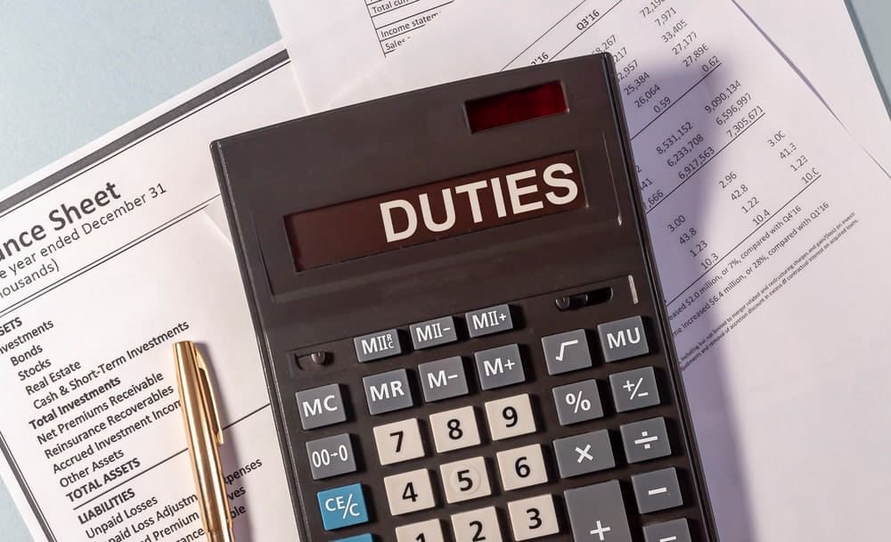 A black calculator with a text that says, "DUTIES"