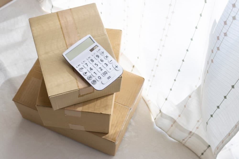 a stack of boxes with a white calculator on top