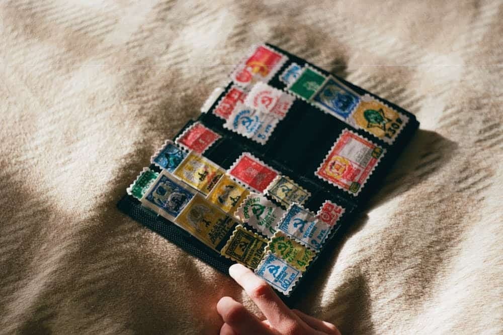 Old stamps stitched on a black pouch