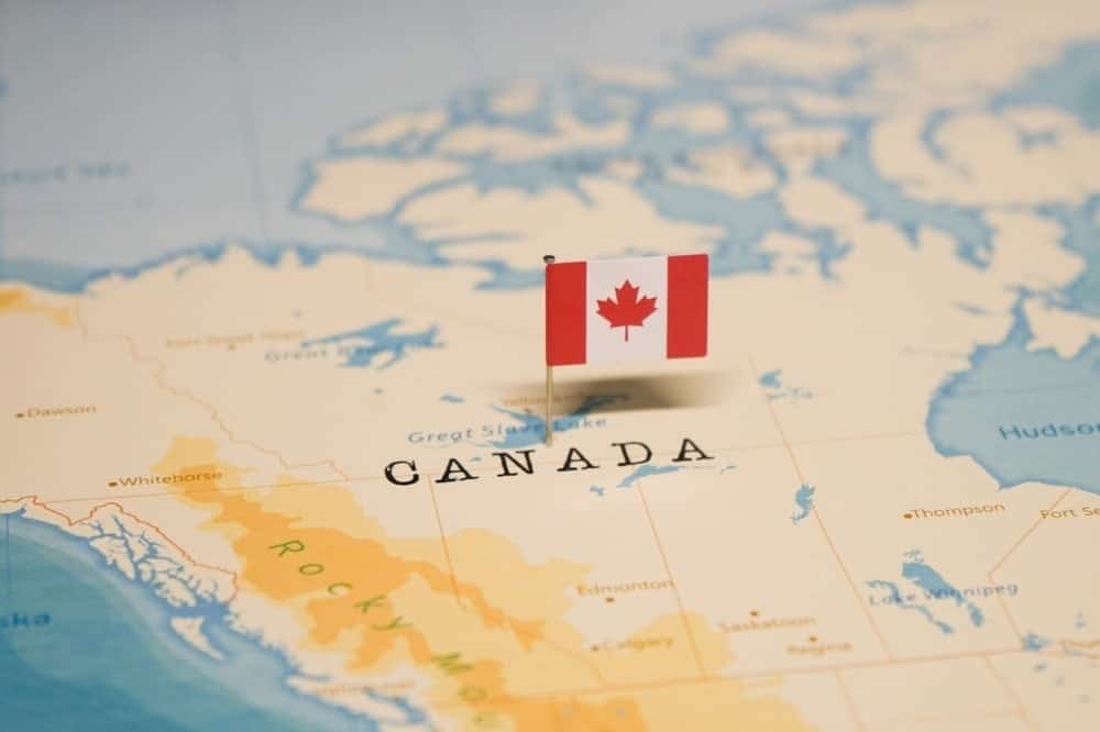 The Canadian flag pinned on the map of Canada