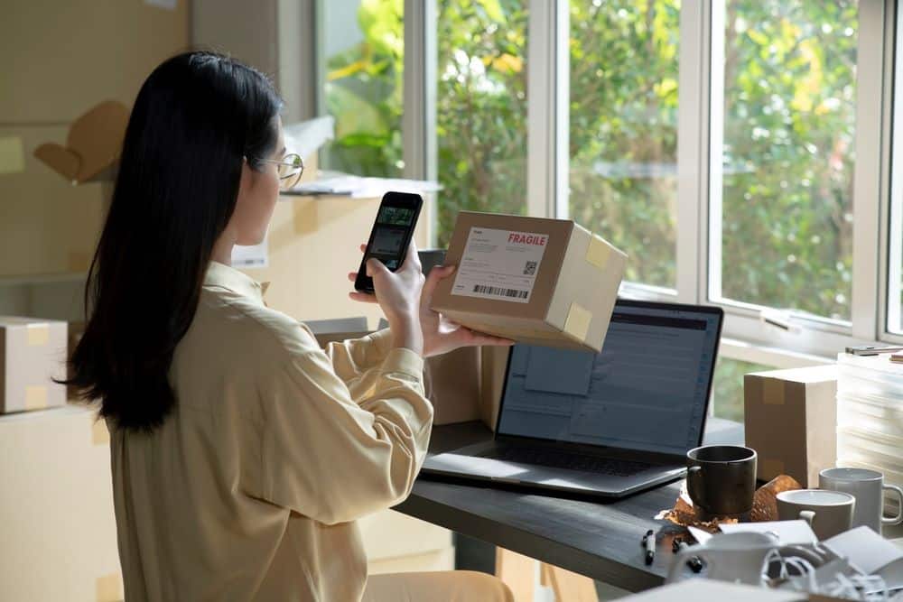 A woman scanning a label on a package